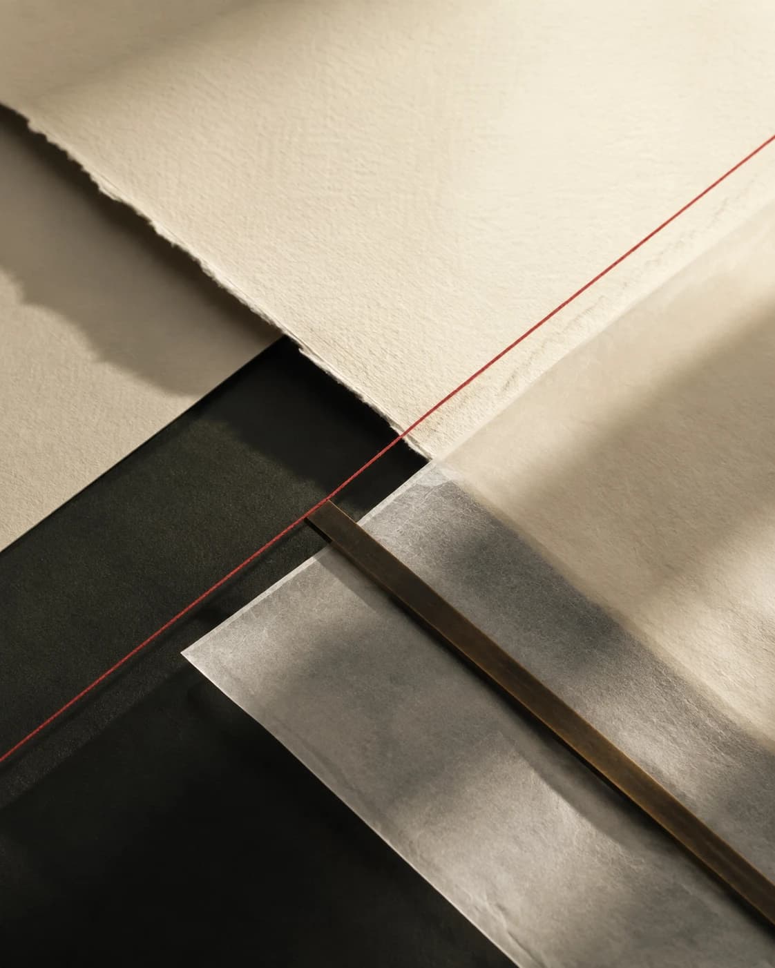 Layered paper, vellum, bronze and a precise red thread